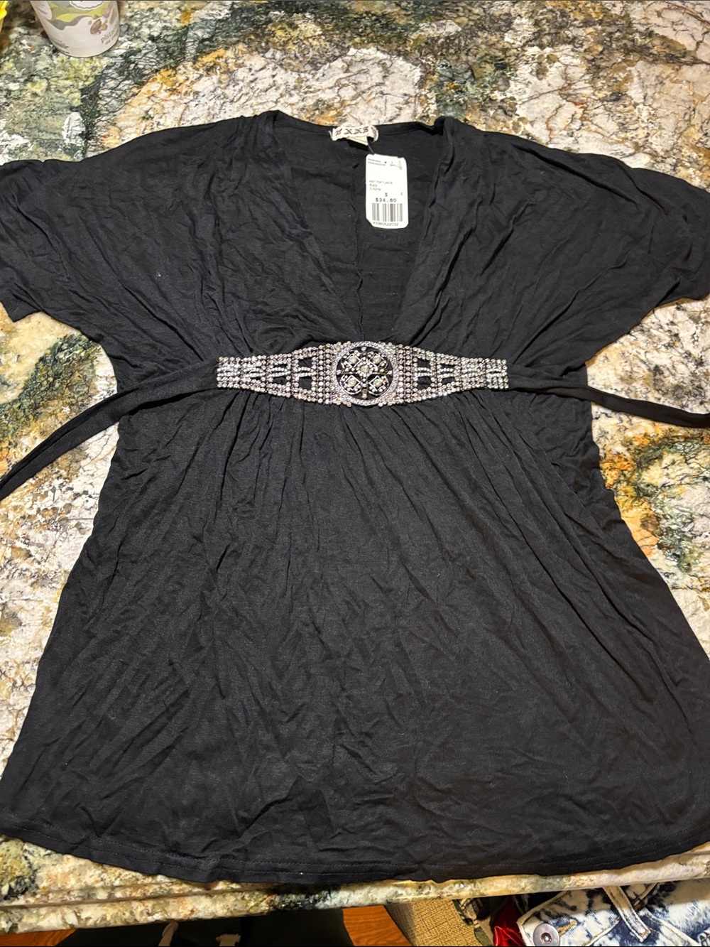Black Women's V-Neck Top with Decorative Waist Accent missing a few crystals
